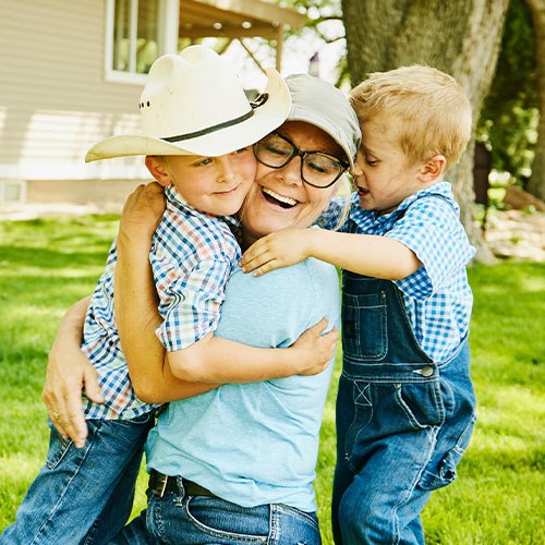 Grandmother hugging grandchildren