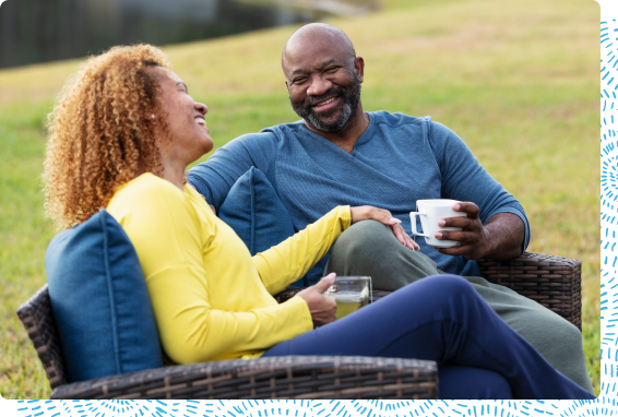 Smiling couple having coffee outside