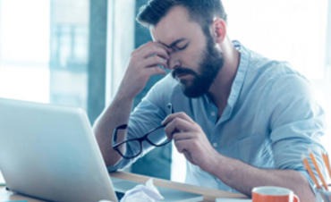 A man feeling stressed at work